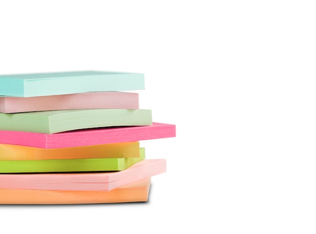 Block of sticky notes on isolated white wall