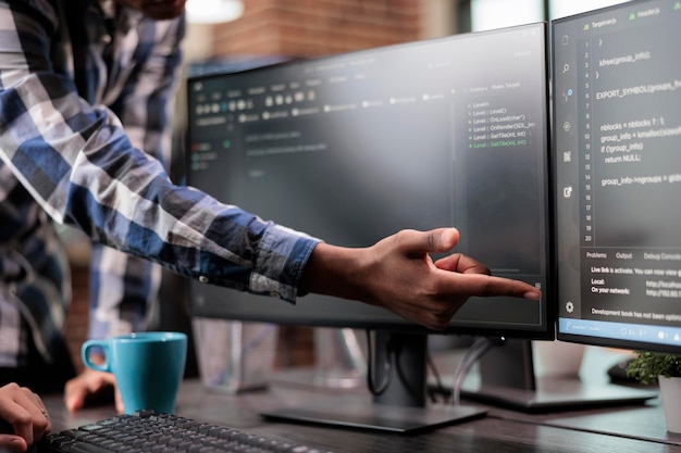 Blockchain engineer pointing out mistake in network security software line code. Cybernetics developers engineering system updates and processing data blocks uploaded by artificial intelligence.