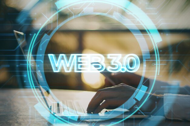 Blockchain system cryptocurrency and modern internet technology concept with blue web 30 sign hologram and hands typing on a laptop background double exposure