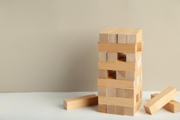 Blocks of wood on grey background Strategy game as a business plan for team work