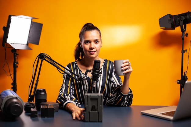 Blogger recording battery review for his podcast in home studio