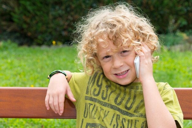 Blond boy using a smartphone