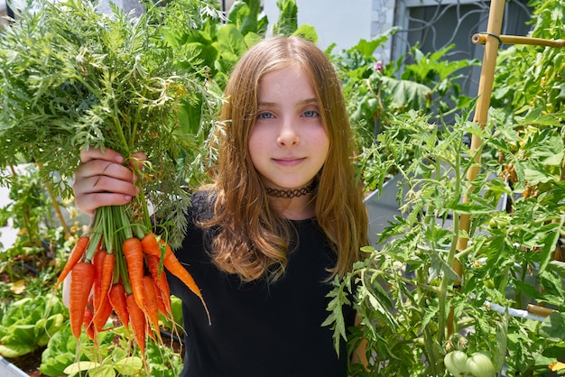 Blond girl harvesting carrots urban orchard