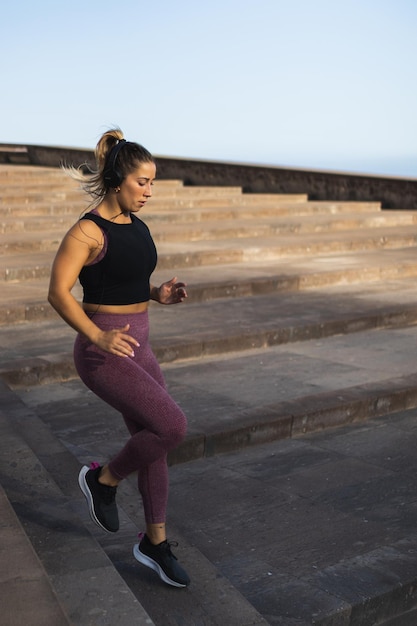 Blond-haired woman running down the stairs