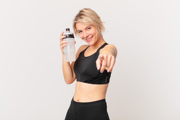 Blond pretty fitness woman with a water bottle