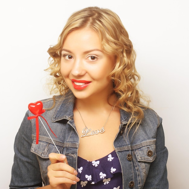 Blond woman holding red heart