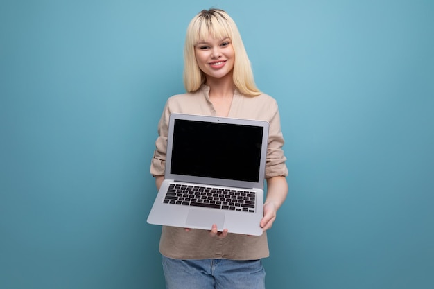 Blond young woman freelancer with laptop computer