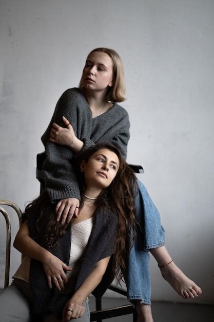 Blonde and brunette models pose in knitwear for a clothing catalog