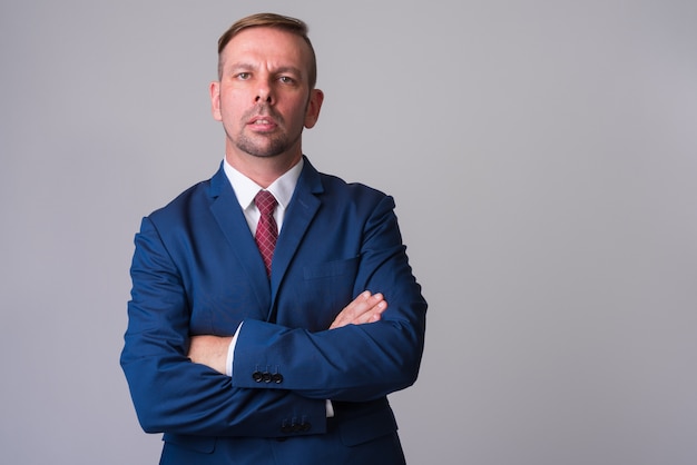 blonde businessman wearing blue suit