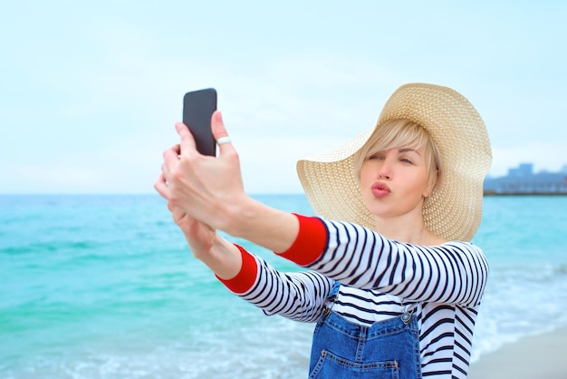 blonde caucasian woman on vacation by the sea