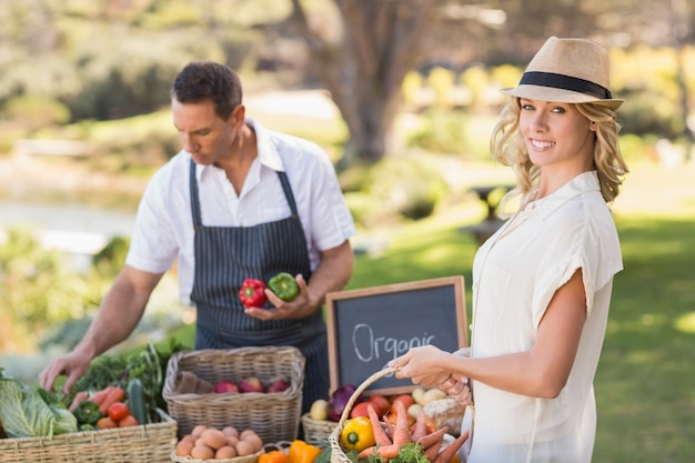 Blonde customer buying some vegetables