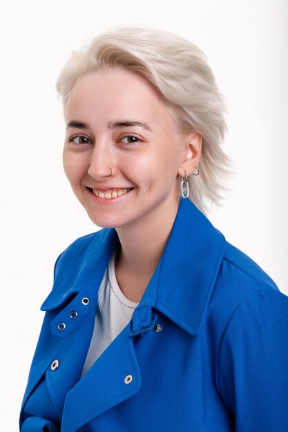 Blonde girl in a blue coat on a white background