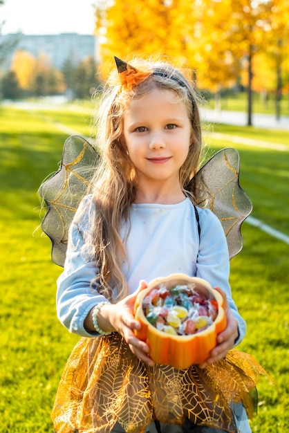 Blonde girl dressed as a witch wizard for halloween Trick or treat the child asks for candy