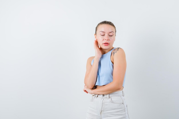 blonde girl is looking at her shoulder on white background