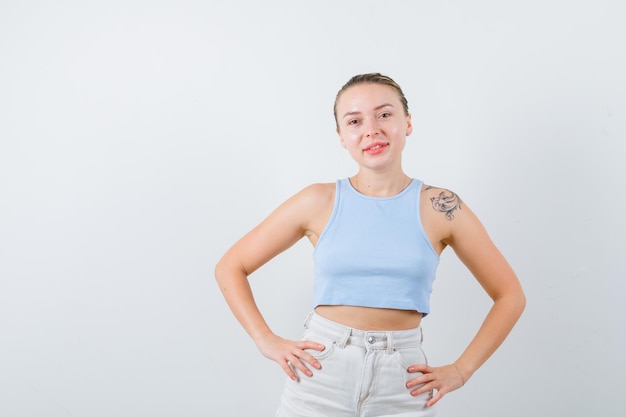 blonde girl is posing at camera on white background