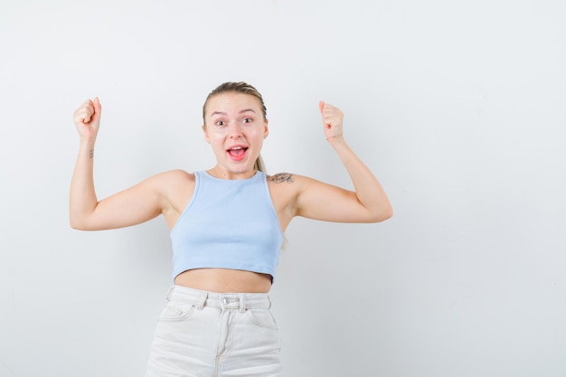 Blonde girl is showing expression happiness on white background