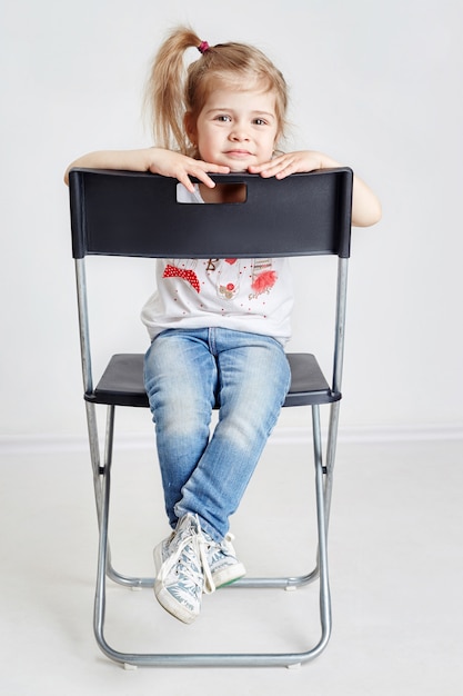 Blonde girl sitting in the Director's chair 