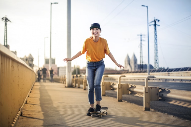 Blonde girl skateboarding in the city