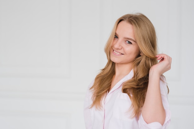 Blonde girl touching her hair