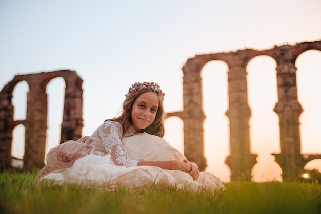 Blonde girl with curly hair dressed in communion dress in Merida