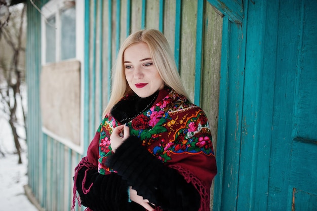 Blonde girl with hand embroidered scarf posed at winter day. Women's handkerchief.