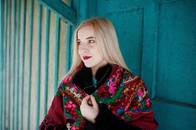 Blonde girl with hand embroidered scarf posed at winter day. Women's handkerchief.