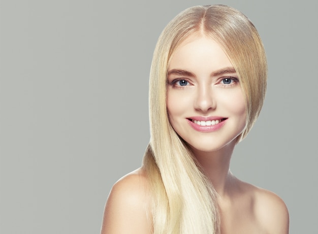 Blonde hair woman natural skin female beauty healthy teeth smile. Studio shot.