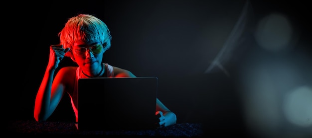 Blonde Hair Woman trade stock cryptocurrency in Laptop for profit playing online games for fun