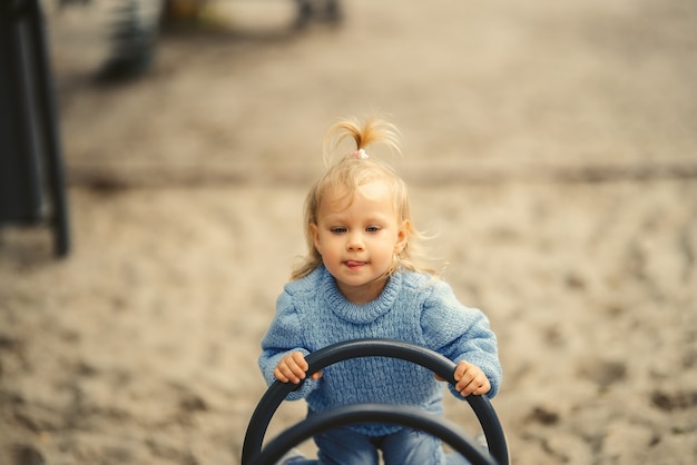 Blonde haired girl at the playground