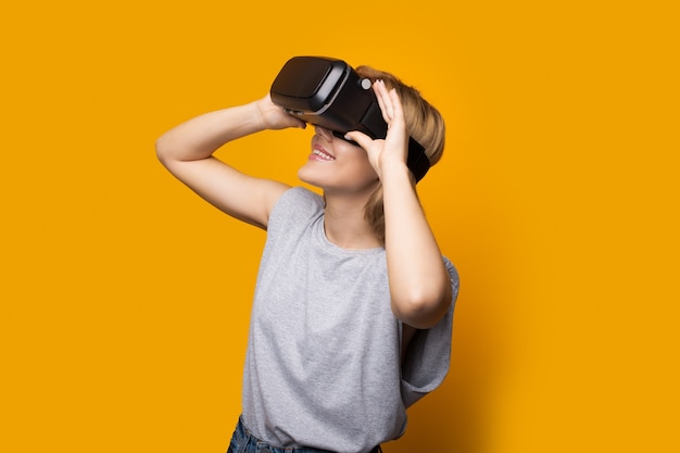 Blonde lady looking up at something using a virtual and augmented reality headset