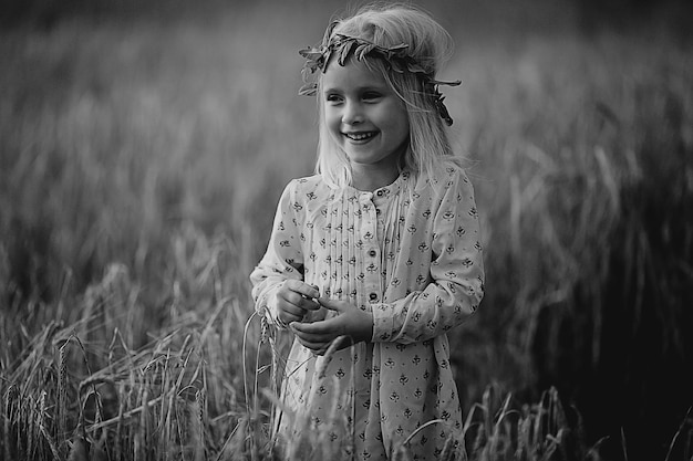 blonde little girl in the field with spikelets