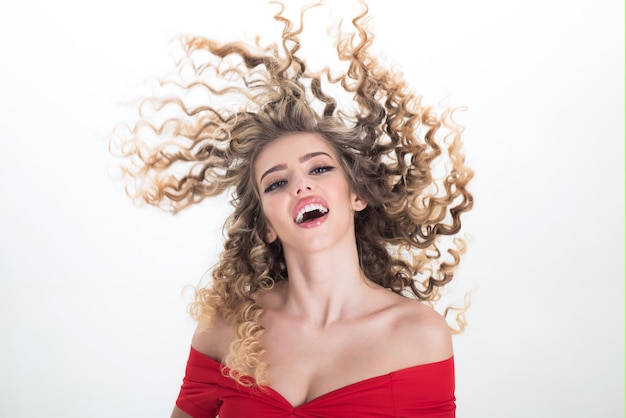 Blonde long hair woman girl with curly hair. Portrait of positive girl with curly hair isolated on white background. Makeup and cosmetics for skin care. Beauty and style. Professional hair care.