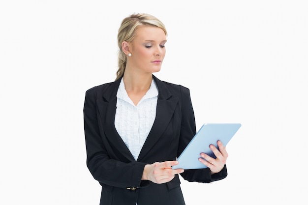 Blonde looking at her tablet