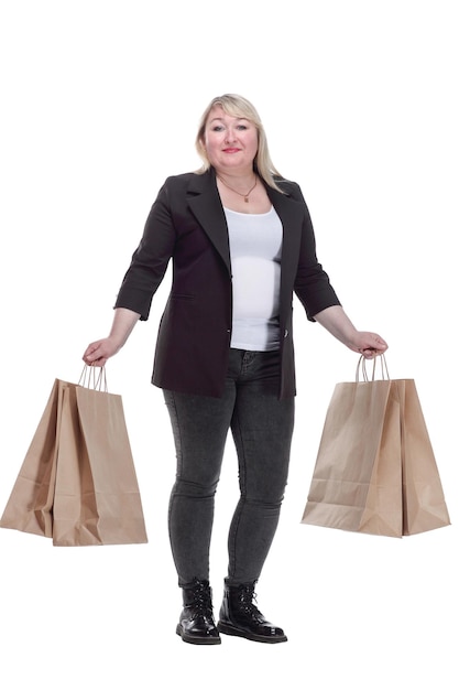 Blonde mature woman with shopping bags  isolated on a white background