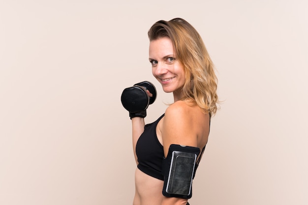 Blonde sport woman making weightlifting