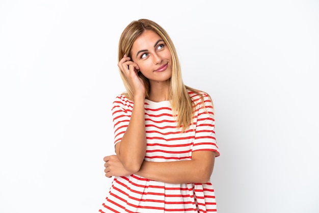 Blonde Uruguayan girl isolated on white background thinking an idea