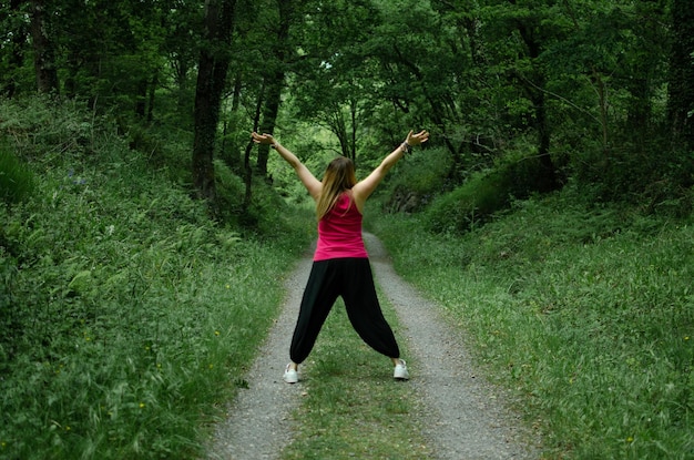 Blonde walks through the woods