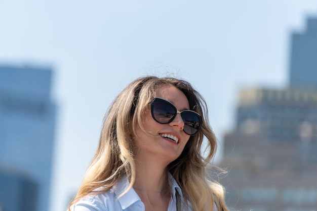 Blonde woman in blue shirt posing