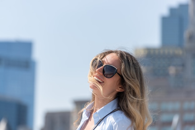 Blonde woman in blue shirt posing