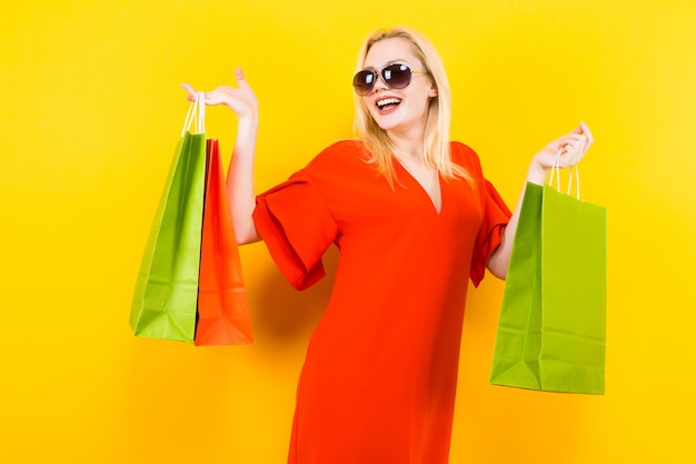 Blonde woman in dress with bags