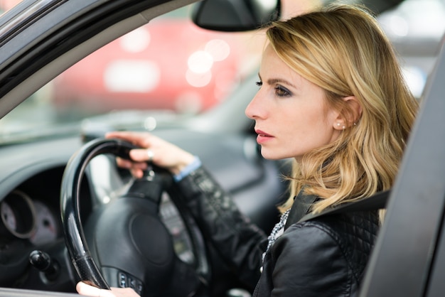 Blonde woman driving her car