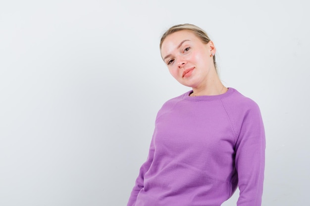 The blonde woman is looking at camera on white background