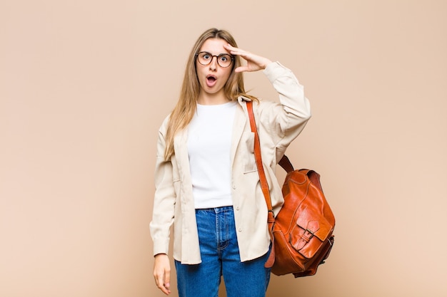 Blonde woman looking astonished and surprised