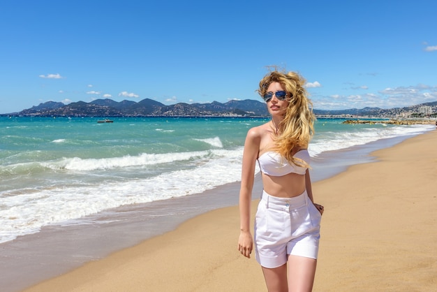 Blonde woman portrait at the beach in Cannes, France