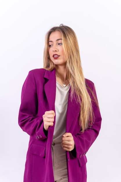 Blonde woman in a portrait isolated on a white background wearing a purple trench coat