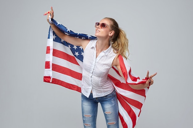 Blonde woman posing with usa flag white