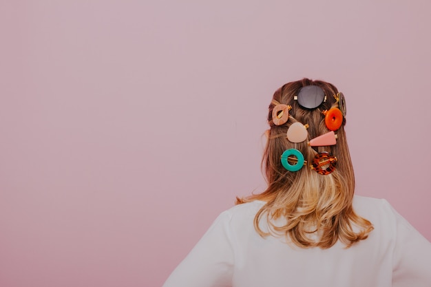 Blonde Woman with Clips in her hair modern hair pins pink wall