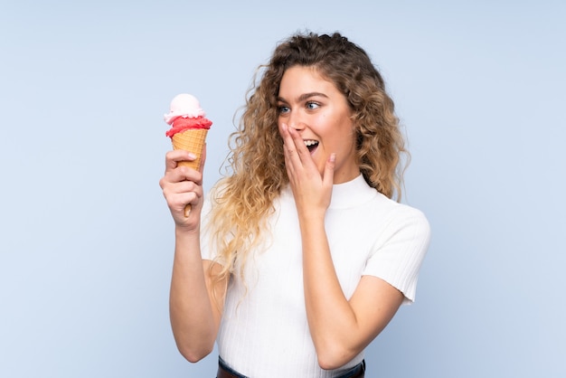 blonde woman with curly hair holding an ice cream