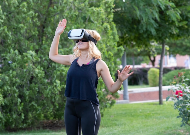 Blonde woman with virtual reality glasses