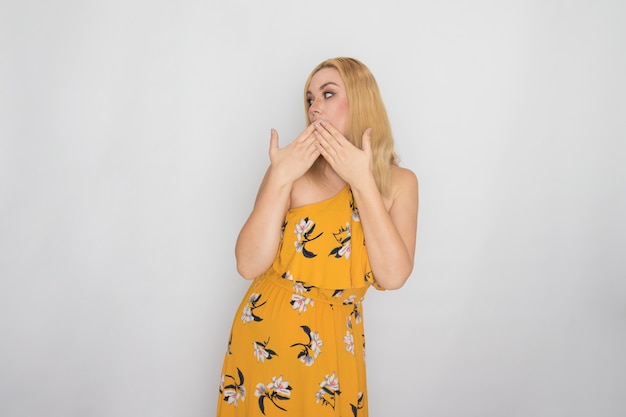 Blonde young woman in yellow floral spring summer dress